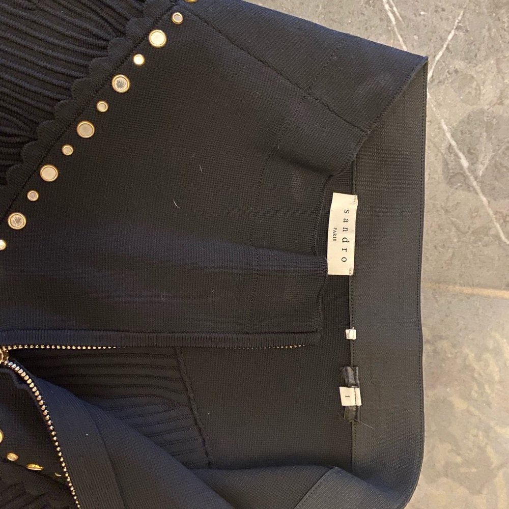 Black A line knit mini skirt with gold zipper in back with embellishments